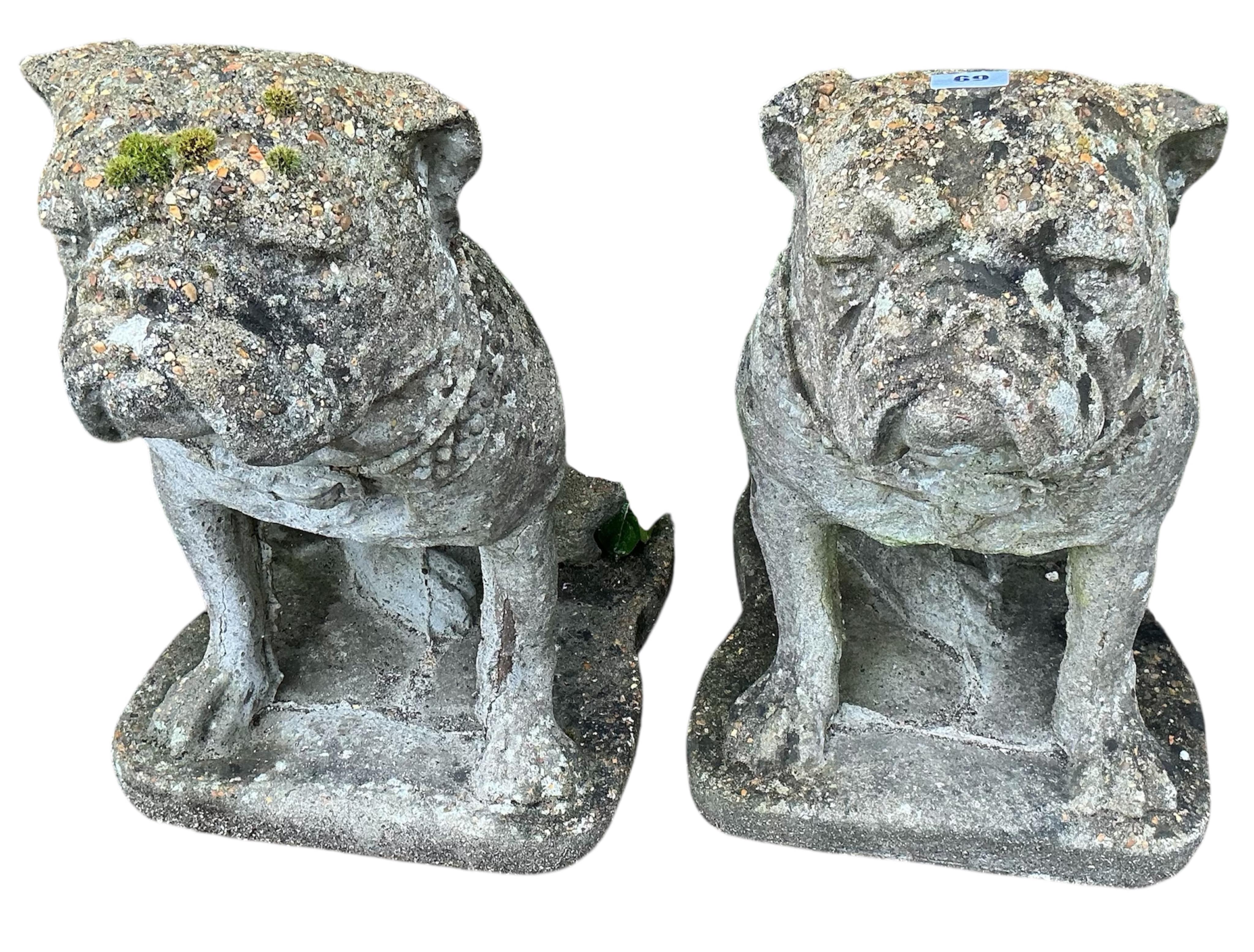 A pair of reconstituted stone bulldog garden ornaments, height 47cm